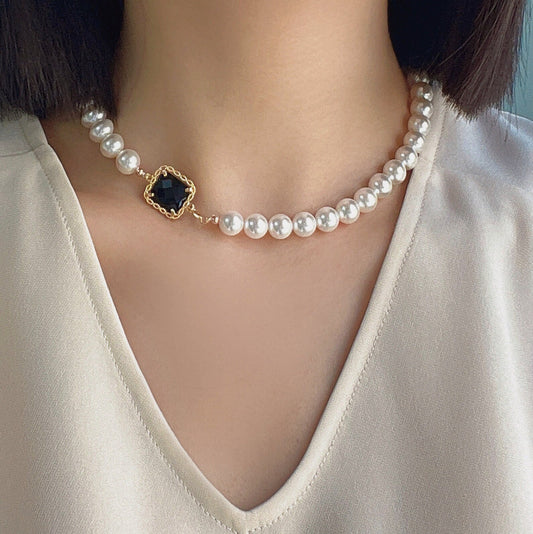 Elegant pearl choker with black pendant